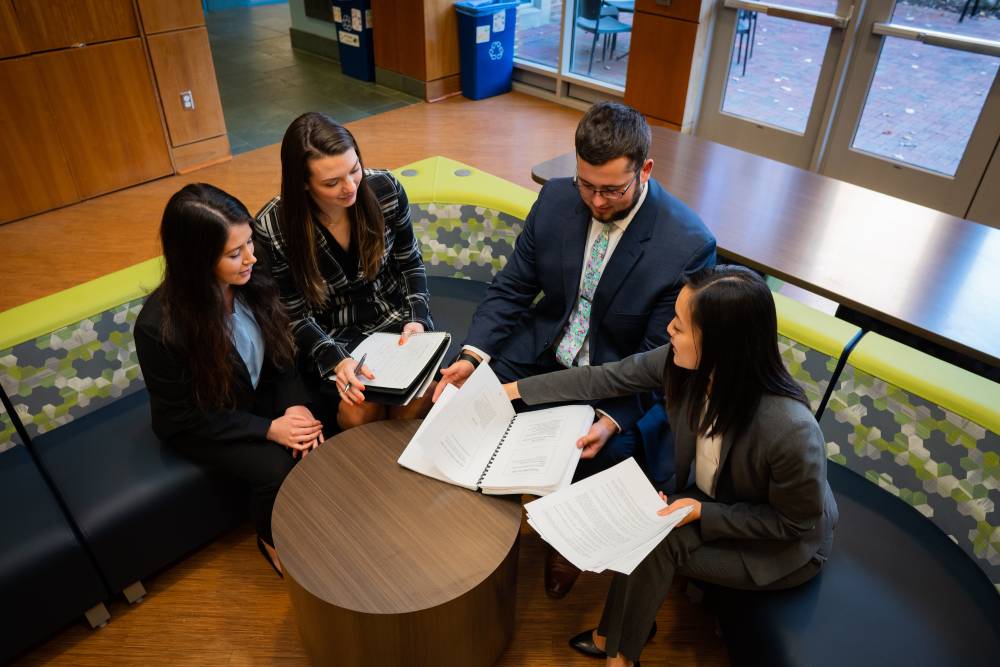 VCU HAD Students discussing documents around a table