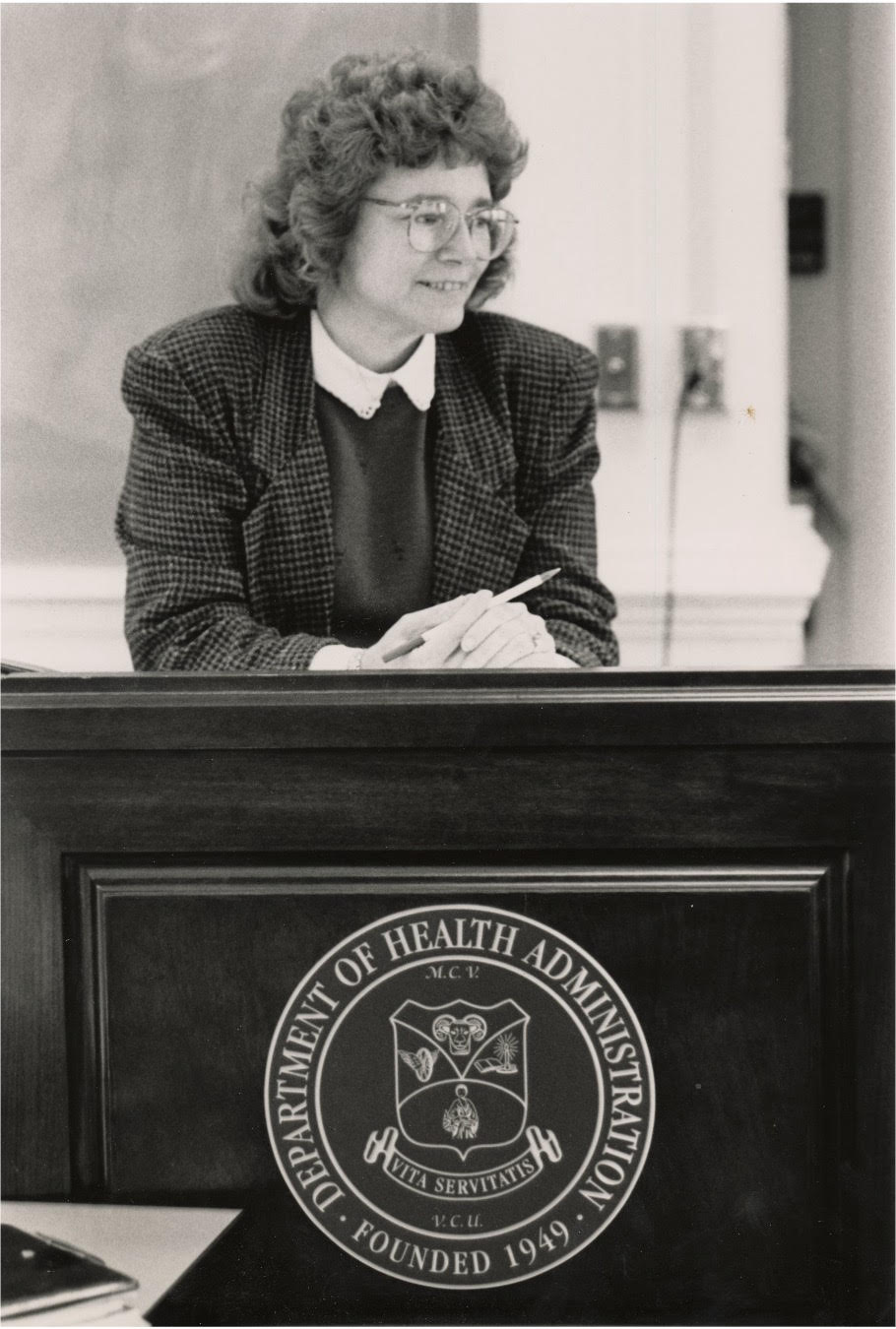 Dolores Clement standing at a podium